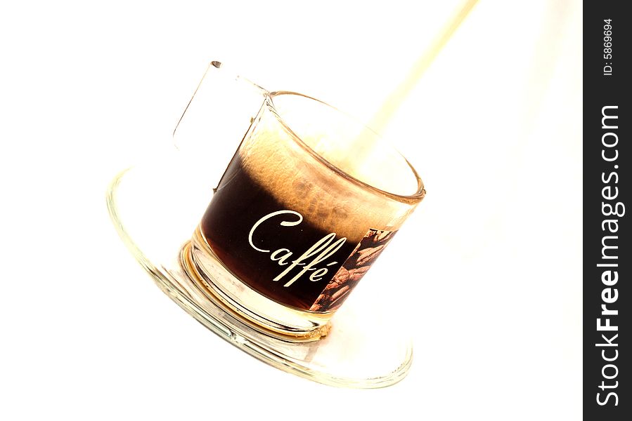 An image of coffee being poured into a coffee cup. (On an angle). An image of coffee being poured into a coffee cup. (On an angle)