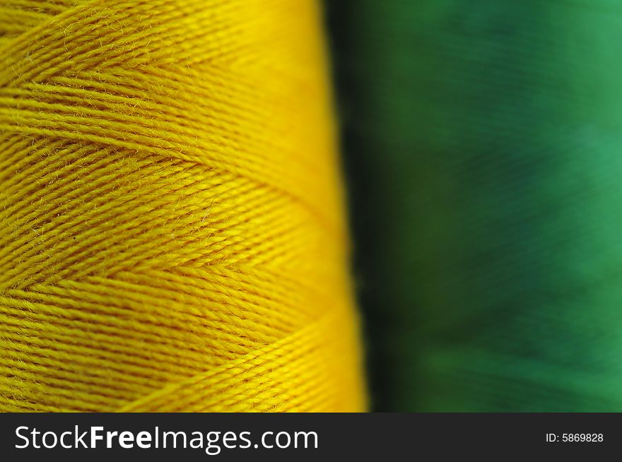 Spool of the coloured threads Macro: green and yellow. Spool of the coloured threads Macro: green and yellow