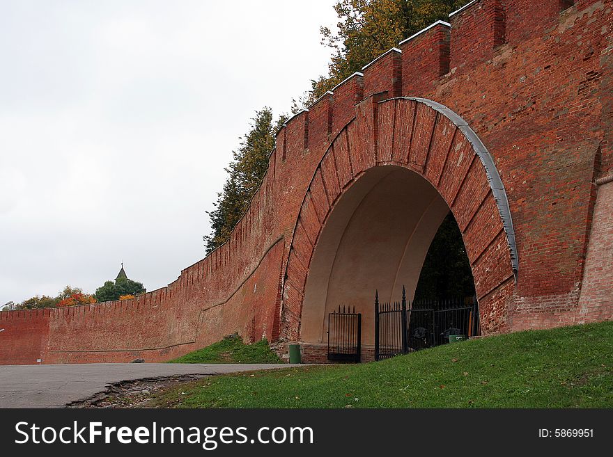 A big wall from red brick with gates. A big wall from red brick with gates