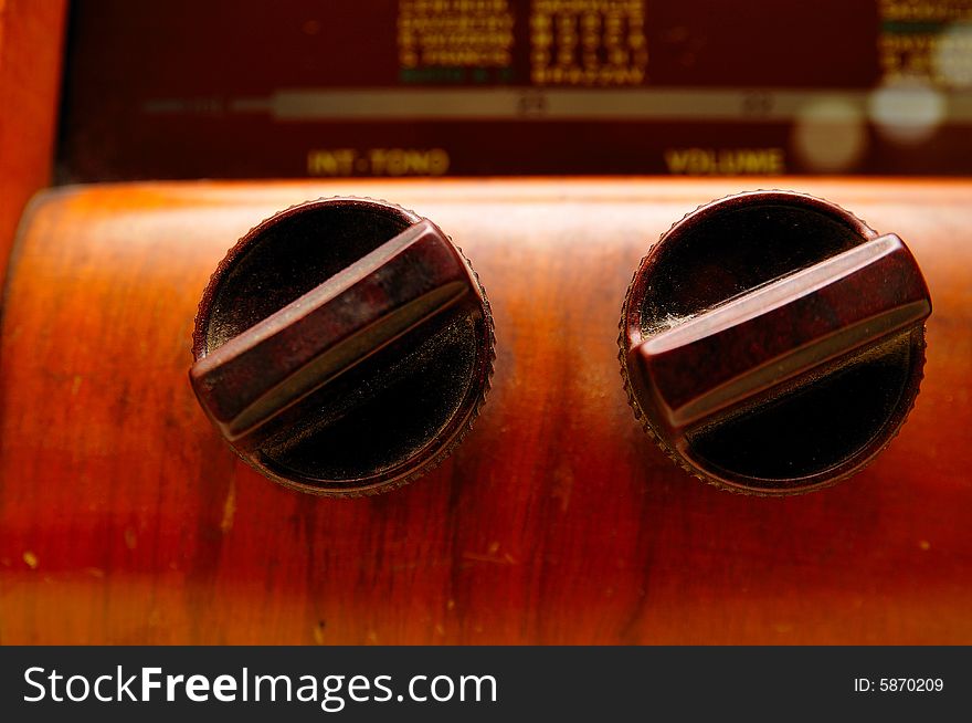 Details of a very old radio. Close shot of knobs. Details of a very old radio. Close shot of knobs.