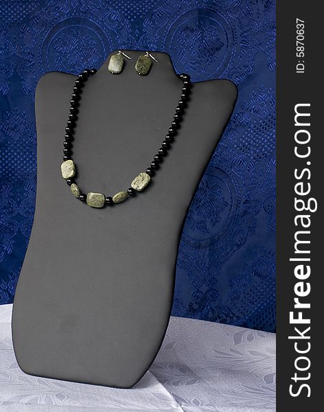 A luxury necklace on a blue background. A luxury necklace on a blue background.