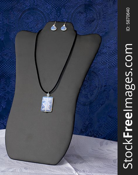 A luxury necklace on a blue background. A luxury necklace on a blue background.