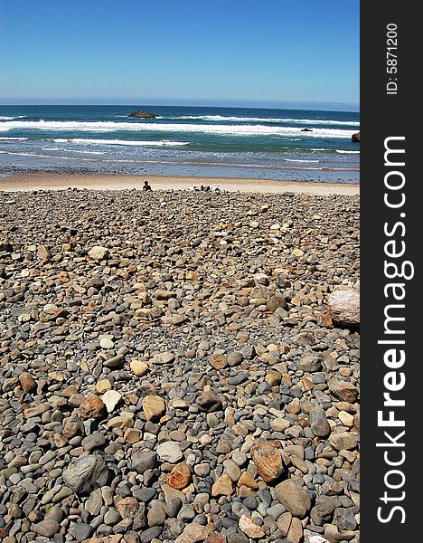 A beach with lots of rocks as the sand. A beach with lots of rocks as the sand.