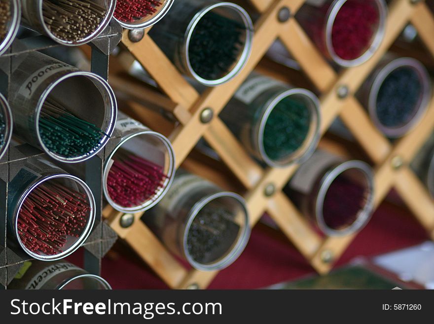 Containers filled with various incense sticks at the Farmer's Market.