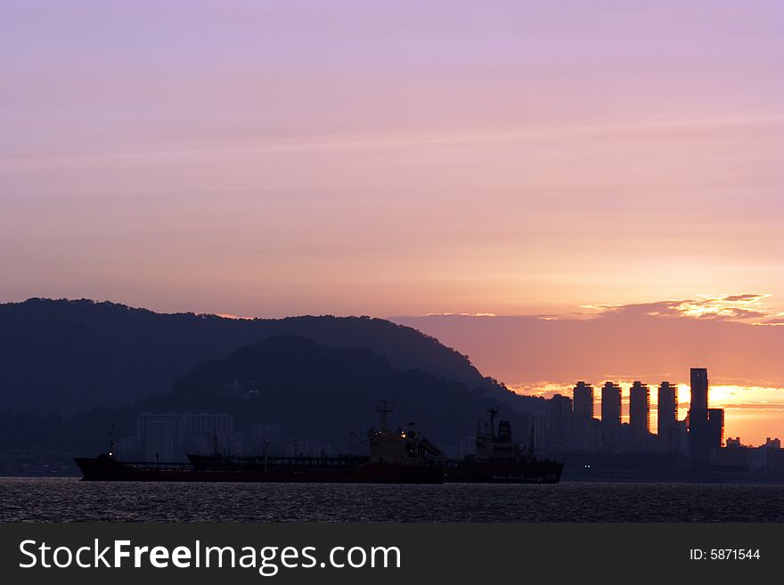 Sunset at harbour near city