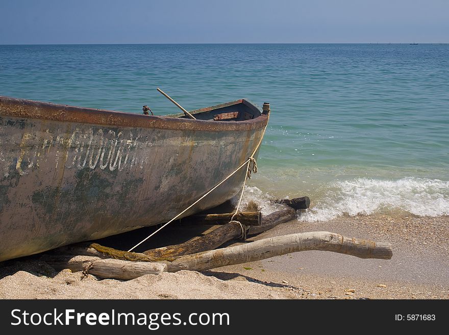 Old fishing vessel beached on sand. Old fishing vessel beached on sand