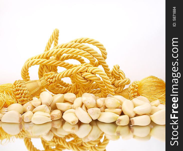 Peeled fresh garlic composition with gold rope. Peeled fresh garlic composition with gold rope