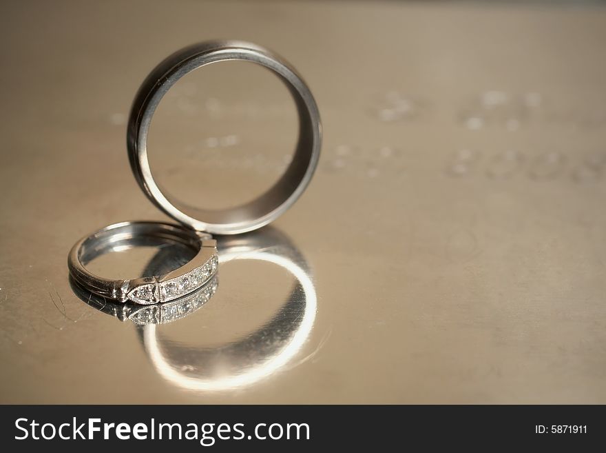 Closeup of silver wedding rings DOF focus on diamonds