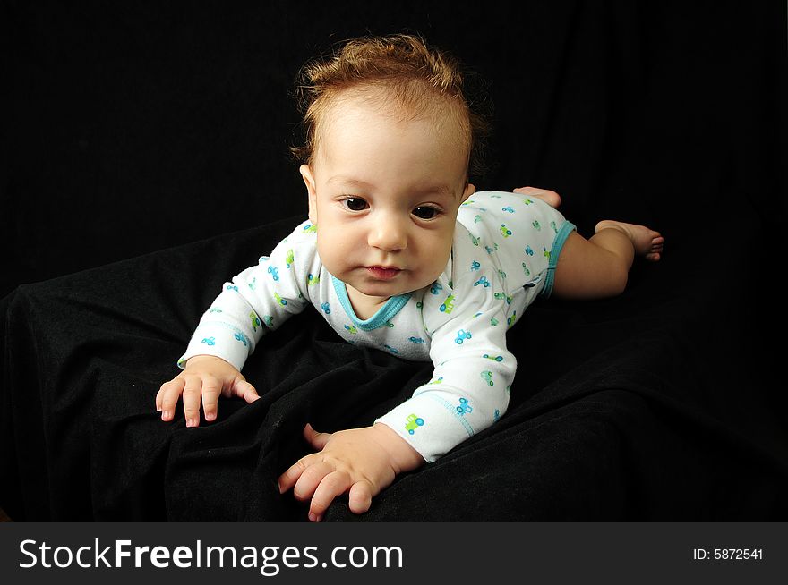 Baby boy isolated over black