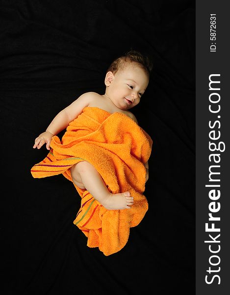 Baby boy isolated over black