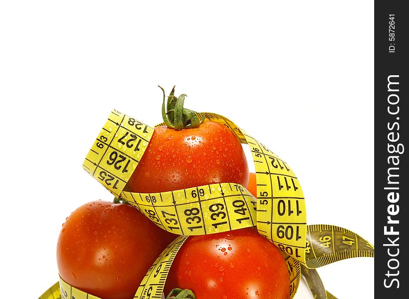 Ripe juicy tomatos and tape measure isolated