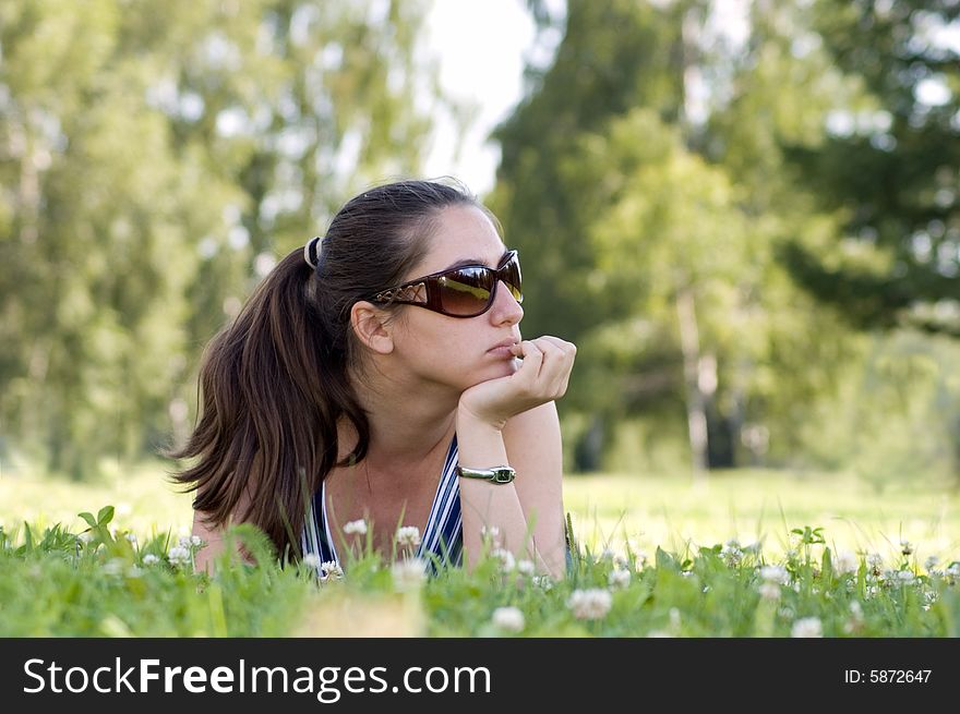 Attractive woman is dreaming in a park. Attractive woman is dreaming in a park