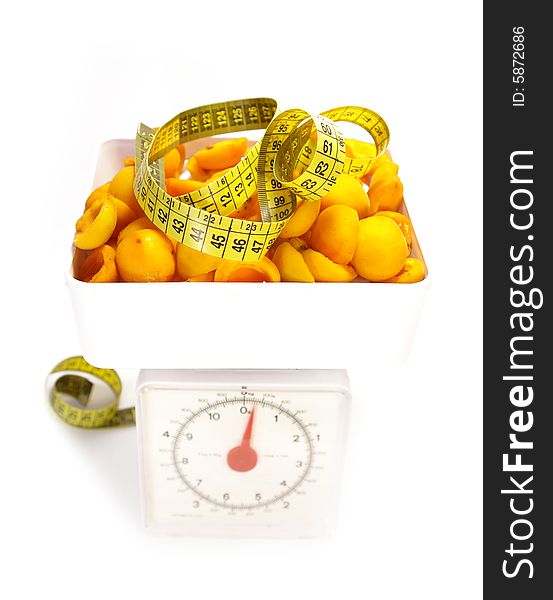 Sweet apricots, scale and tape measure isolated. Sweet apricots, scale and tape measure isolated