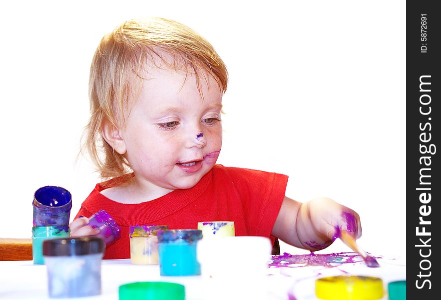 Little girl draws on a table isolated. Little girl draws on a table isolated