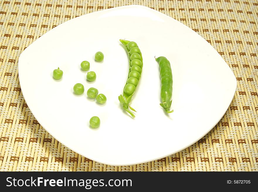 Ripe pea isolated on a white plate. Ripe pea isolated on a white plate