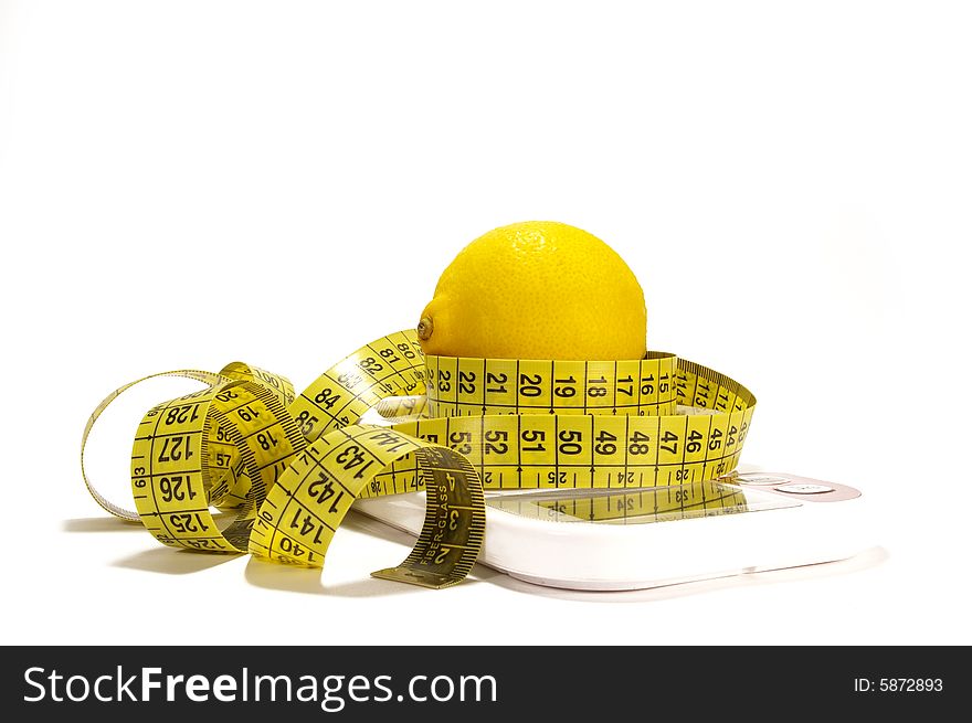 Lemon and tape measure on scale isolated. Lemon and tape measure on scale isolated