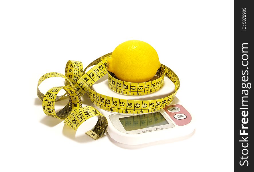 Lemon and tape measure on scale isolated