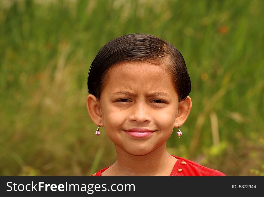 A playful and bright face of a small girl. A playful and bright face of a small girl.