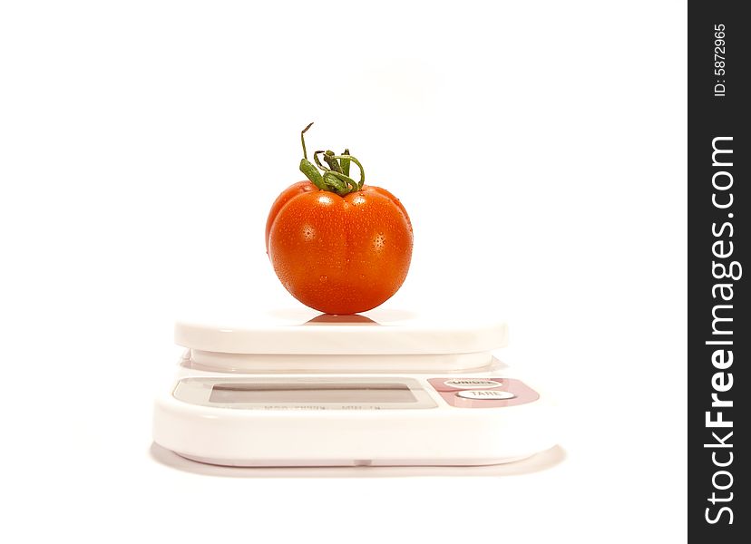 Juicy tomato and scale isolared on white background