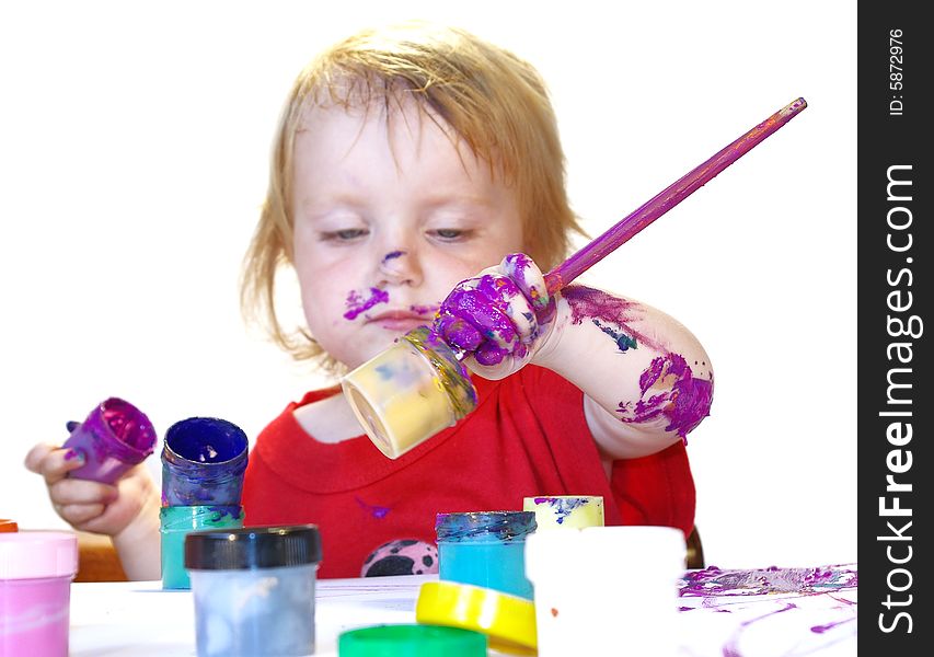 Little girl draws on a table isolated. Little girl draws on a table isolated