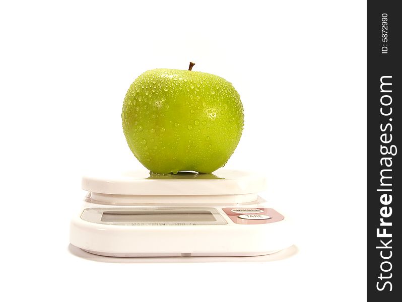 Green apple and scale isolared on white background