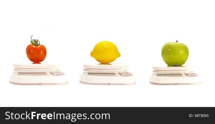 Apple, lemon and tomato on the scale isolated. Apple, lemon and tomato on the scale isolated