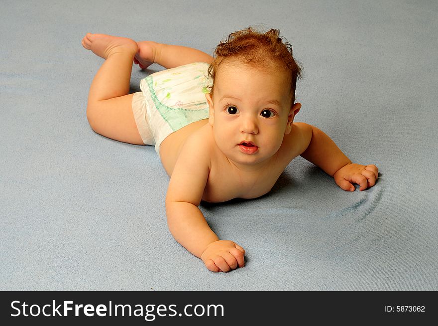 Baby boy isolated over blue