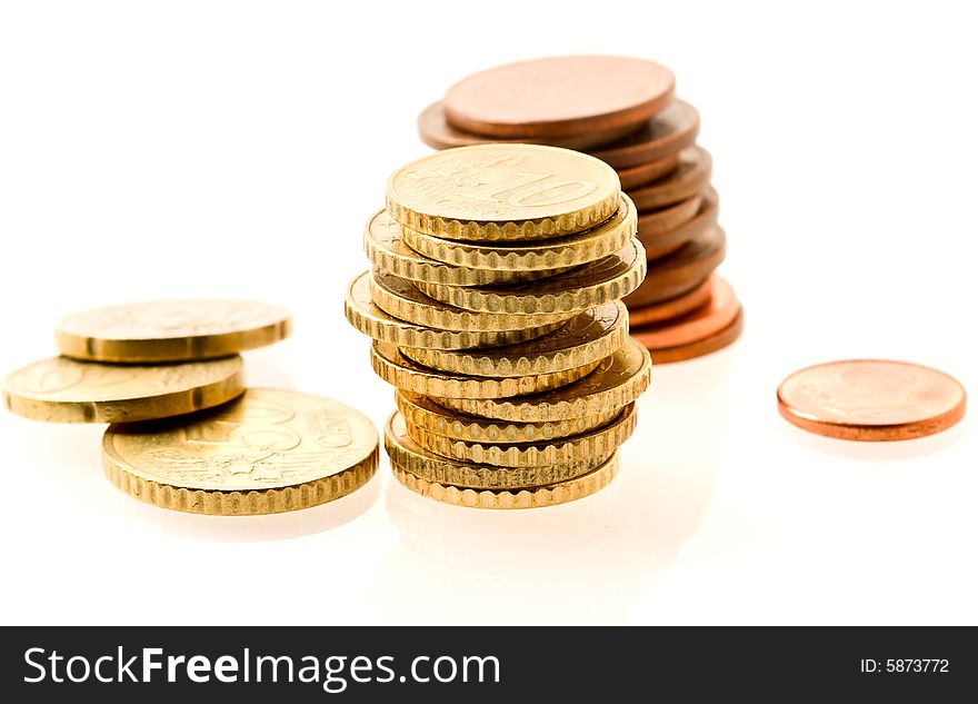 Piles of european coins over white. Shallow DOF