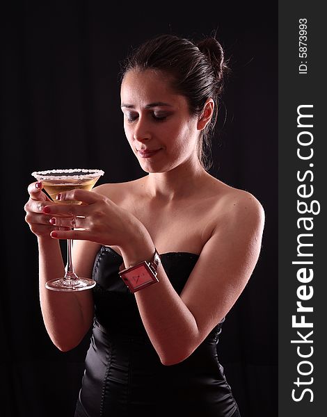 Beautiful young woman holding a martini glass. Beautiful young woman holding a martini glass