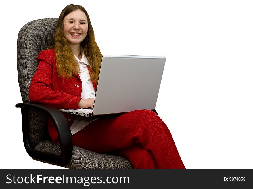 The young girl sits on an armchair with notebook. The young girl sits on an armchair with notebook