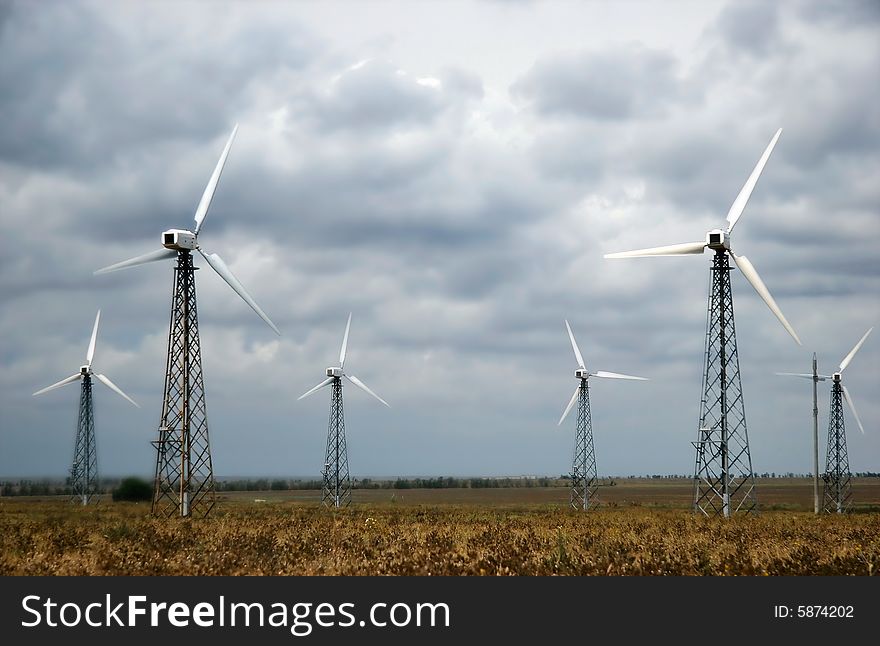 Group of wind turbines over sky background