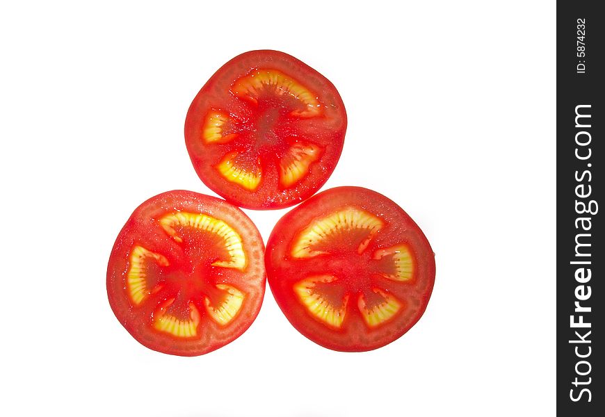 The ripe juicy tomato cut on a part on a white background