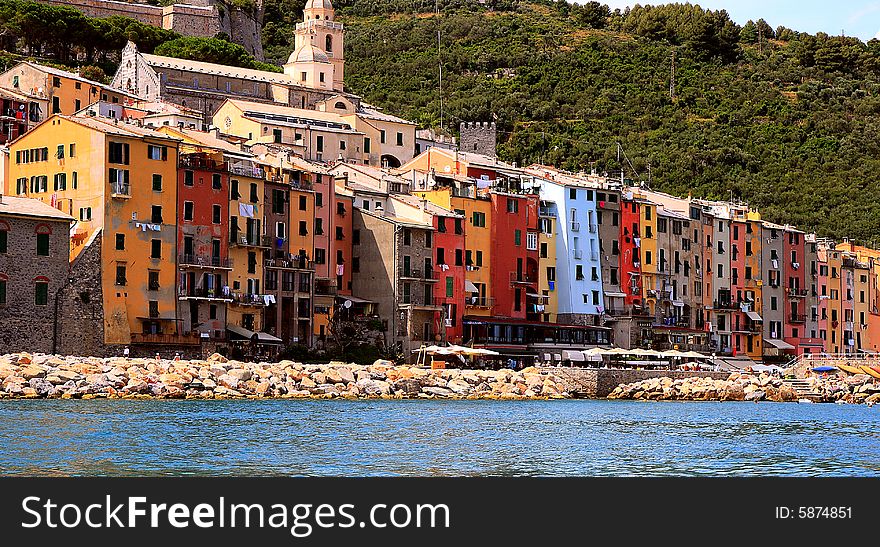 Fishing boats on a harbor with the seafront view of Portovenere in Italy.