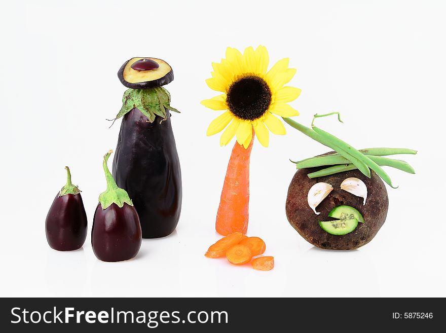 Composition from carrots with a sunflower and beets with an eggplant