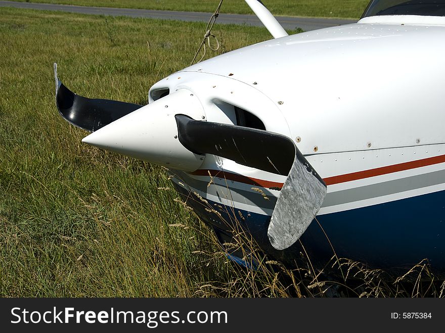 Front of a private airplane with a severely damaged propeller. Front of a private airplane with a severely damaged propeller