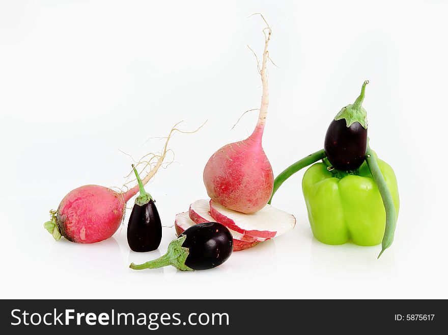 Composition from green pepper, a siliculose string bean and an eggplant with a garden radish. Composition from green pepper, a siliculose string bean and an eggplant with a garden radish