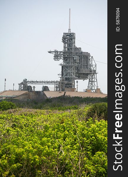 This stock photo depicts the natural flora and fauna growth leading to the Kennedy  Space Center launch complex 39 where the Space Shuttle is launched in Cape Canaveral Florida. On top of the launch complex is the 80 foot lightning mast. This stock photo depicts the natural flora and fauna growth leading to the Kennedy  Space Center launch complex 39 where the Space Shuttle is launched in Cape Canaveral Florida. On top of the launch complex is the 80 foot lightning mast.