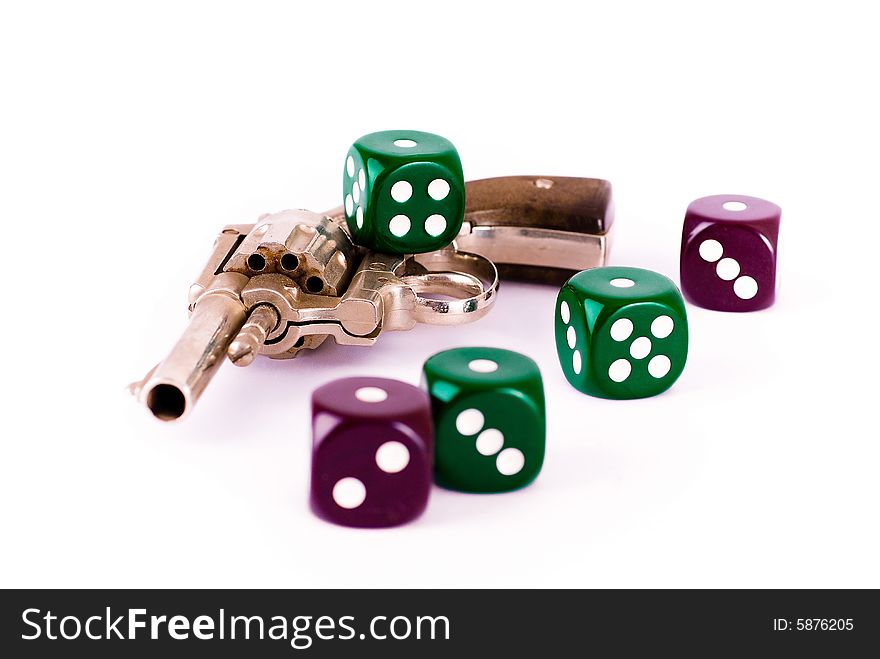 Gun and dice on the white background