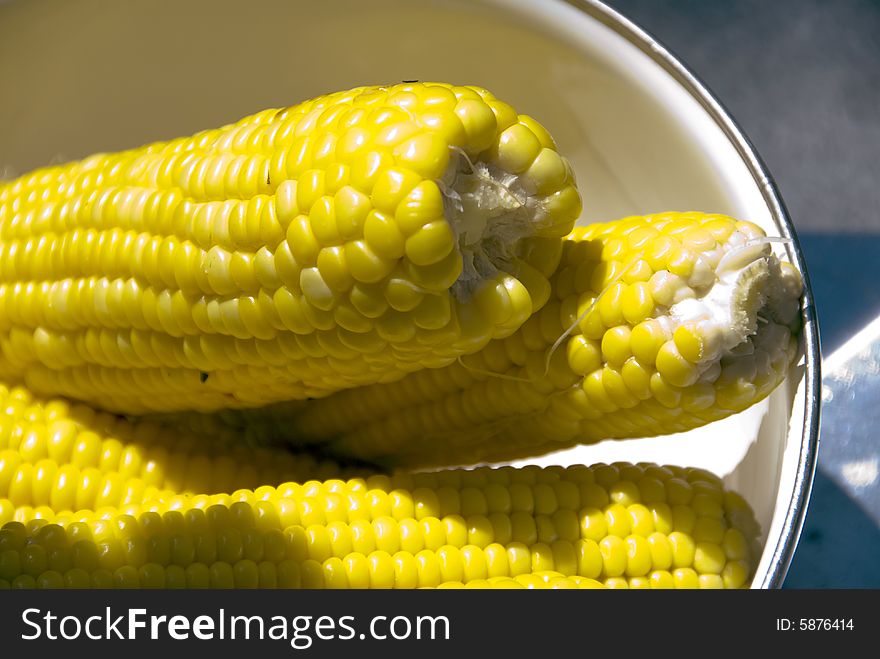 Stacks of hot, buttered corn on the cob.