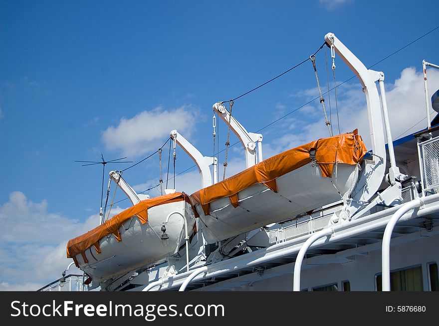 Two safe boats and blue sky with clouds. Two safe boats and blue sky with clouds