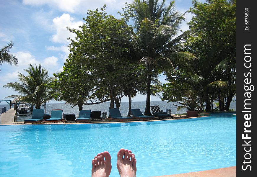 Relaxing by a pool in the caribbean. Relaxing by a pool in the caribbean