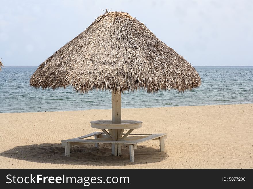 Beach of the Bay of Trujillo, Honduras. clear sands, sea and typical parasol. Beach of the Bay of Trujillo, Honduras. clear sands, sea and typical parasol.