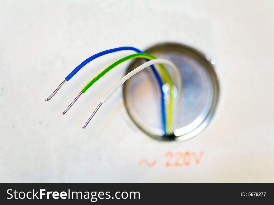 Color wires of an electric cable and terminal box, located on a plasterboard