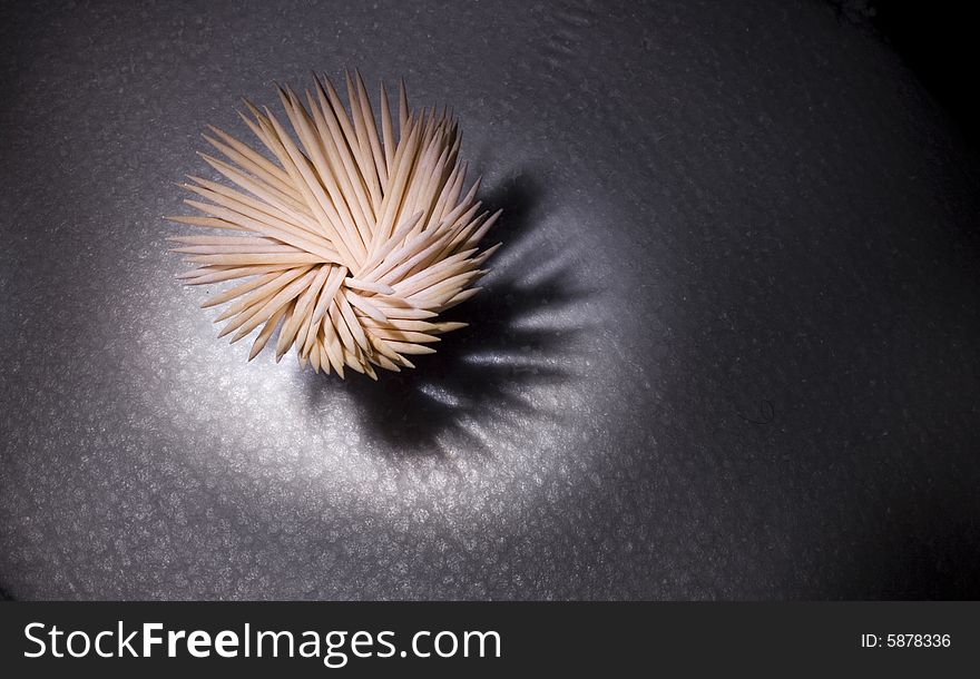 Toothpick and shadow on abstract background