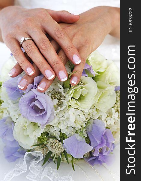 The bride holds a wedding bouquet