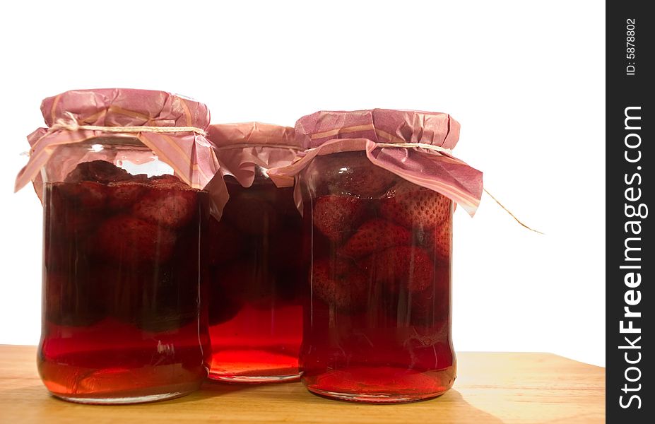 Strawberry in sugar syrup on wooden board, home made. Strawberry in sugar syrup on wooden board, home made.