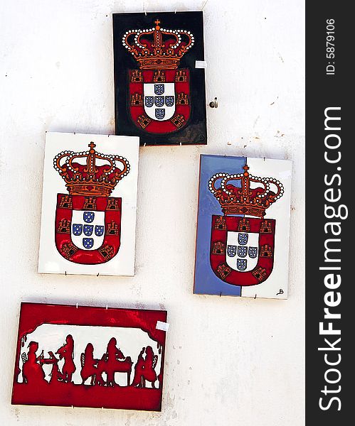 Portugal, Obidos situated in the district of Leiria is a small medieval fortified city well preserved turned into a tourist attraction. View of a wall decorated with portuguese coat of arms. Portugal, Obidos situated in the district of Leiria is a small medieval fortified city well preserved turned into a tourist attraction. View of a wall decorated with portuguese coat of arms.