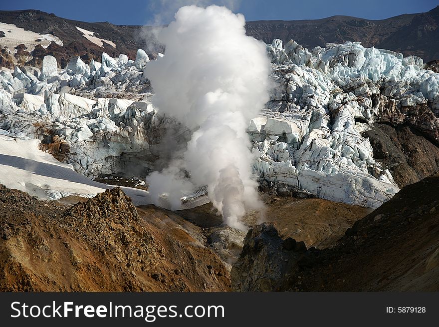 In crater acting vulcan possible to see blue ice and smoke.