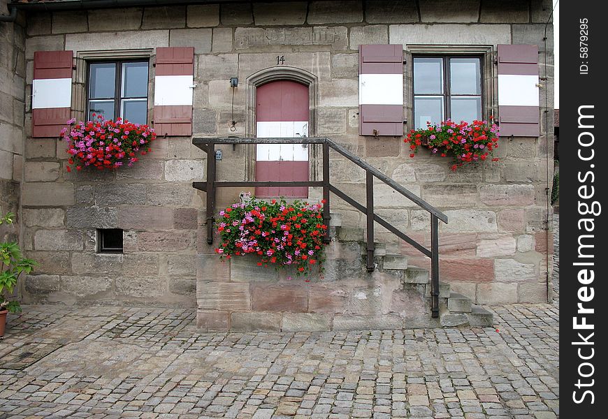 Wonderful close-up of castle home - complete with flower boxes and natural stone - in an ancient castle in Germany. Wonderful close-up of castle home - complete with flower boxes and natural stone - in an ancient castle in Germany.