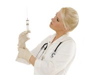 Young Female Doctor Looking At Syringe Stock Images Young Female Doctor Looking At Syringe Stock Images